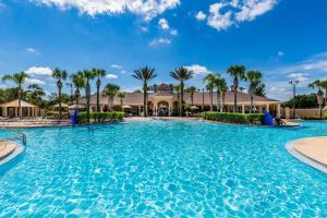 a large pool at a resort with palm trees at Fabulous 3 Bedroom Condo 2 miles from Disney in Orlando