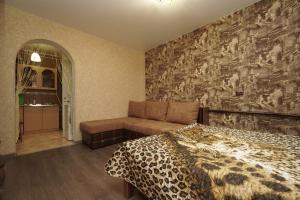 a bedroom with a bed and a couch at Apartments Colonnade in Kislovodsk