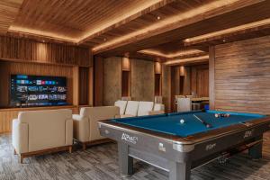 a billiard room with a pool table and chairs at Elevate Bali in Munduk