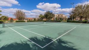 a tennis court with a net on it at Orlando Disney Holiday Palace in Orlando