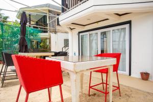 a table with four chairs and an umbrella on a patio at La Suerte Villa in Boracay