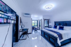 a bedroom with a bed and a desk in it at Platinum22 - Across From AC Marriott Hotel in Kingston +18 photos