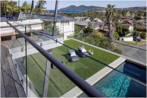 an aerial view of a house with a swimming pool at Beach, Golf & Luxury! Sunrise to Sunset Views in Forster