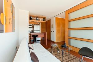 a living room with a white couch and a table at City Inn Apart Home in Santiago