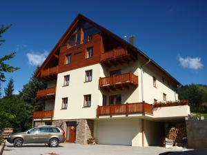 a building with a car parked in front of it at HORSKÁ CHATA SOBÍK in Dolní Morava