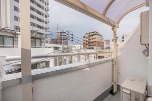 a balcony with a view of a city at Shinjuku Wind Apartment • Cozy Retreats in Tokyo