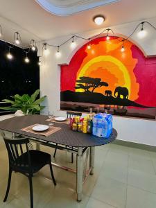 a table in a room with a painting on the wall at Gem's House 1- Balcony with Riverside View in Ho Chi Minh City