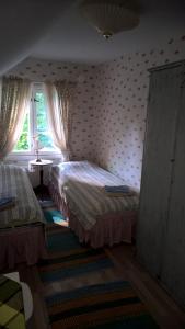 a bedroom with two beds and a window at Majatalo Martta in Nauvo