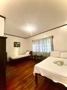 a hotel room with two beds and a window at Jala Beach Resort in Villalimpia