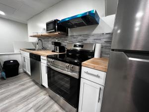 a kitchen with a stove and a refrigerator at The Gorge Getaway 3BR 1BATH Close to Falls in Niagara in Niagara Falls +7 photos