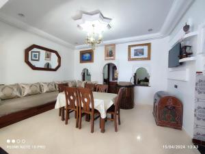 a living room with a table and a couch at Dar NABIL in Chefchaouen