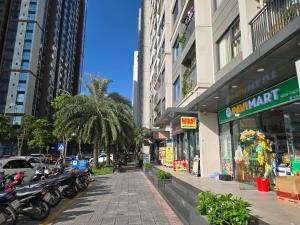 a street with motorcycles parked in front of buildings at Happy Home S112 in Gia Lâm Pho