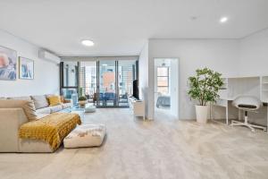 a living room with a couch and a table at Little Bay Haven-Stylish Coastal Apartment in Sydney