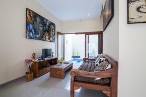 スミニャックにあるThe Lavana Villa De Kerobokanのソファとテレビのあるリビングルーム +9枚の写真