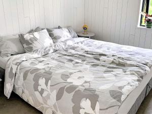 a large bed in a bedroom with a blanket on it at 4 star holiday home in Håcksvik in Håcksvik