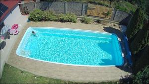 an overhead view of a swimming pool with a person in it at Diana Resort in Timişoara
