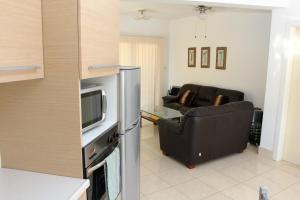 sala de estar con TV y sofá en Villa Christina, en Pafos