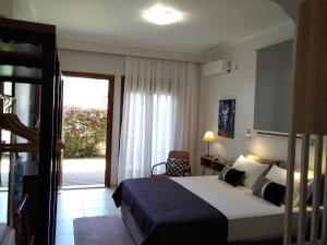 a hotel room with a bed and a window at Villa Adelais App in Tsoukaladhes +19 photos