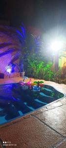 a swimming pool at night with a light at Pousada Ray Sol - Centro Arraial d Ajuda in Arraial d'Ajuda