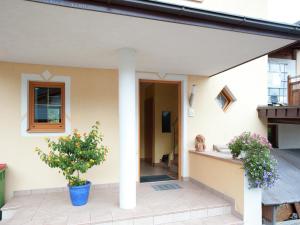 a house with a pillar and plants on the porch at Apartment near the ski area in the Salzburg region in Altenmarkt im Pongau