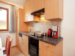 a kitchen with wooden cabinets and a counter top at Apartment near the ski area in the Salzburg region in Altenmarkt im Pongau