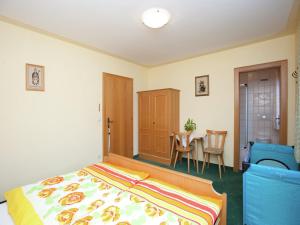 a bedroom with a bed and a table and chairs at Apartment near the ski area in the Salzburg region in Altenmarkt im Pongau +17 photos