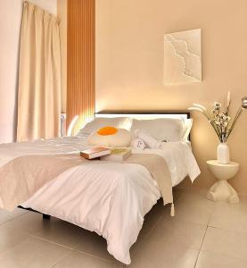 a bedroom with a white bed with a table at SsrHome325 Light Luxury Floating Bed B&B Seremban4r3b B&B 轻奢风格 in Seremban