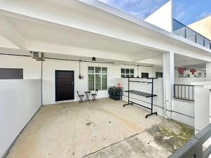 a large white garage with a table and chairs at SsrHome325 Light Luxury Floating Bed B&B Seremban4r3b B&B 轻奢风格 in Seremban