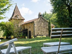an old stone building with a bench in front of it at Cosy holiday home with garden in Villefranche-du-Périgord +32 photos