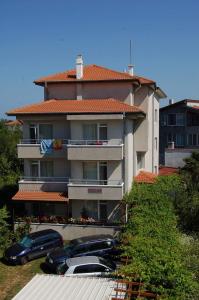 a large building with cars parked in front of it at Prestige in Sinemorets