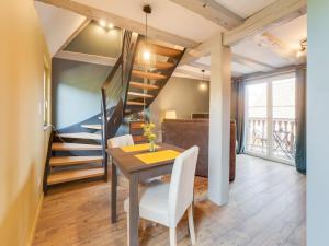 a dining room with a table and a staircase at Apartment in Alsace near Haut-Koenigsbourg in Dambach-la-Ville