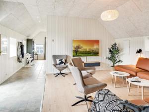 a living room with a couch and a chair at 5 star holiday home in Ringkøbing in Ringkøbing