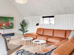 a living room with a couch and a table at 5 star holiday home in Ringkøbing in Ringkøbing