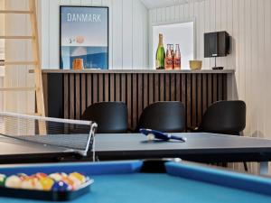a ping pong table with chairs and a bar at Luxury Retreat in Klegod - By Traum Ferienwohnungen in Ringkøbing