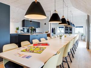 a large dining room with a long table and chairs at 5 star holiday home in Ringkøbing in Ringkøbing +43 photos