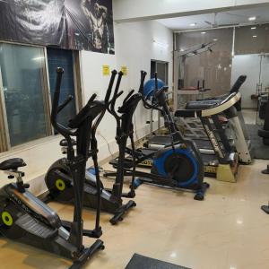 a gym with several cardio machines in a room at Hotel Times Stay in Udaipur