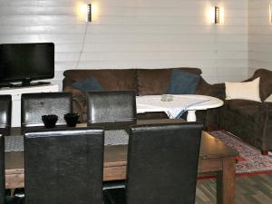 a living room with a couch and a table with two laptops at 7 person holiday home in Selje-By Traum in Selje +16 photos
