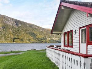 a house with a view of a lake and mountains at 7 person holiday home in Selje-By Traum in Selje