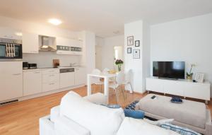 a living room with white furniture and a kitchen at Charming Maraska in Zadar