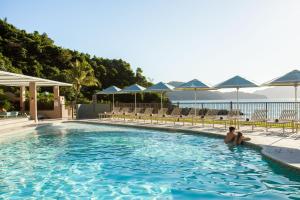 a man sitting in a swimming pool at a hotel at The Sundays in Hamilton Island +16 photos