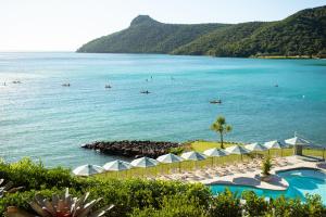 a view of a beach with umbrellas and the ocean at The Sundays in Hamilton Island