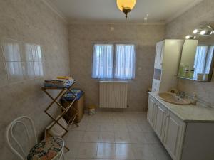 a bathroom with a sink and a mirror and a window at Gîte paisible à Villemandeur avec jardin, près de Montargis - FR-1-590-579 in Villemandeur