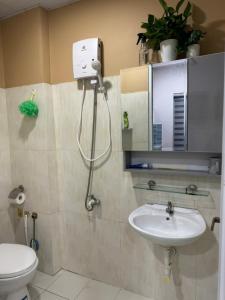 a bathroom with a shower and a sink at Peach Peach Home 2 in Ấp Mỹ Hòa +11 photos