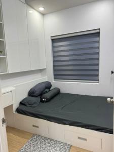 a bed with two pillows and a window in a room at Peach Peach Home 2 in Ấp Mỹ Hòa