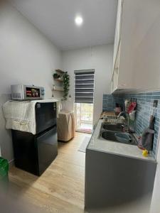 a kitchen with a sink and a stove at Peach Peach Home 2 in Ấp Mỹ Hòa