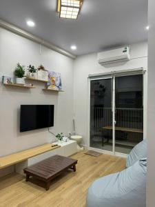 a living room with a tv and a couch at Peach Peach Home 2 in Ấp Mỹ Hòa
