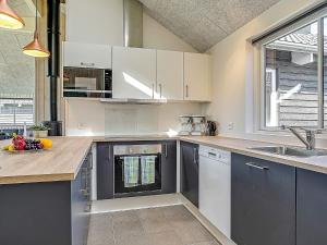 a kitchen with white cabinets and a sink at 5 star holiday home in Kappeln in Kappeln