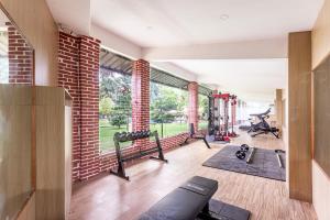 a gym with several treadmills and a brick wall at Hotel Seven Limited in Sauraha