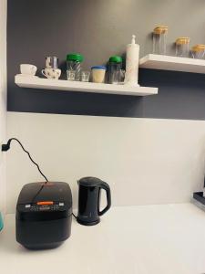 a kitchen counter with a toaster and a coffee maker on it at Suoi Da Villa 