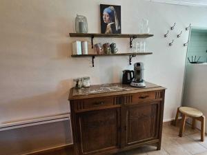 a wooden cabinet in a room with shelves on the wall at Holiday Home in Pionsat near Volcano Park in Pionsat
